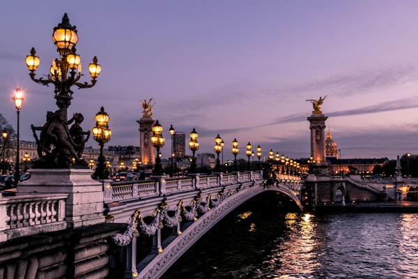 A historic bridge over the Seine in Paris at night